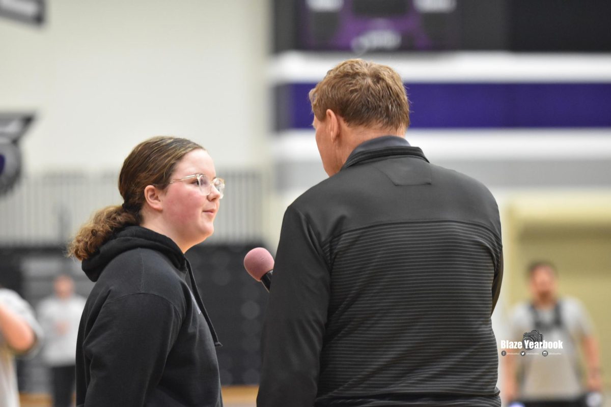 Abby Rozzoni (9) introduces herself to Mark Murphy before she asks the players her question during the Q & A.