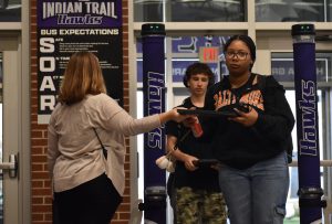 As she exits the metal detectors for the first time, Jayla Whitfield (10) retrieves her Chromebook from Assistant Principal Molly Sheahan-Spector.